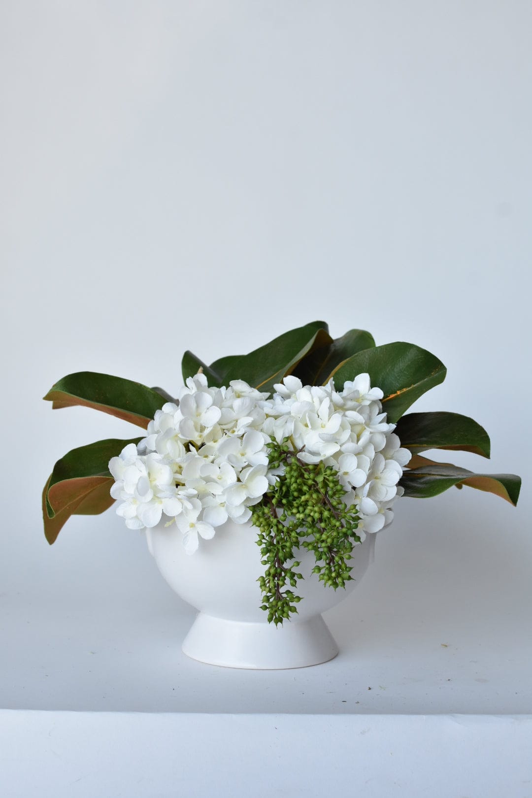 White Hydrangea + Magnolia Leaf Arrangement with Faux Ring Details