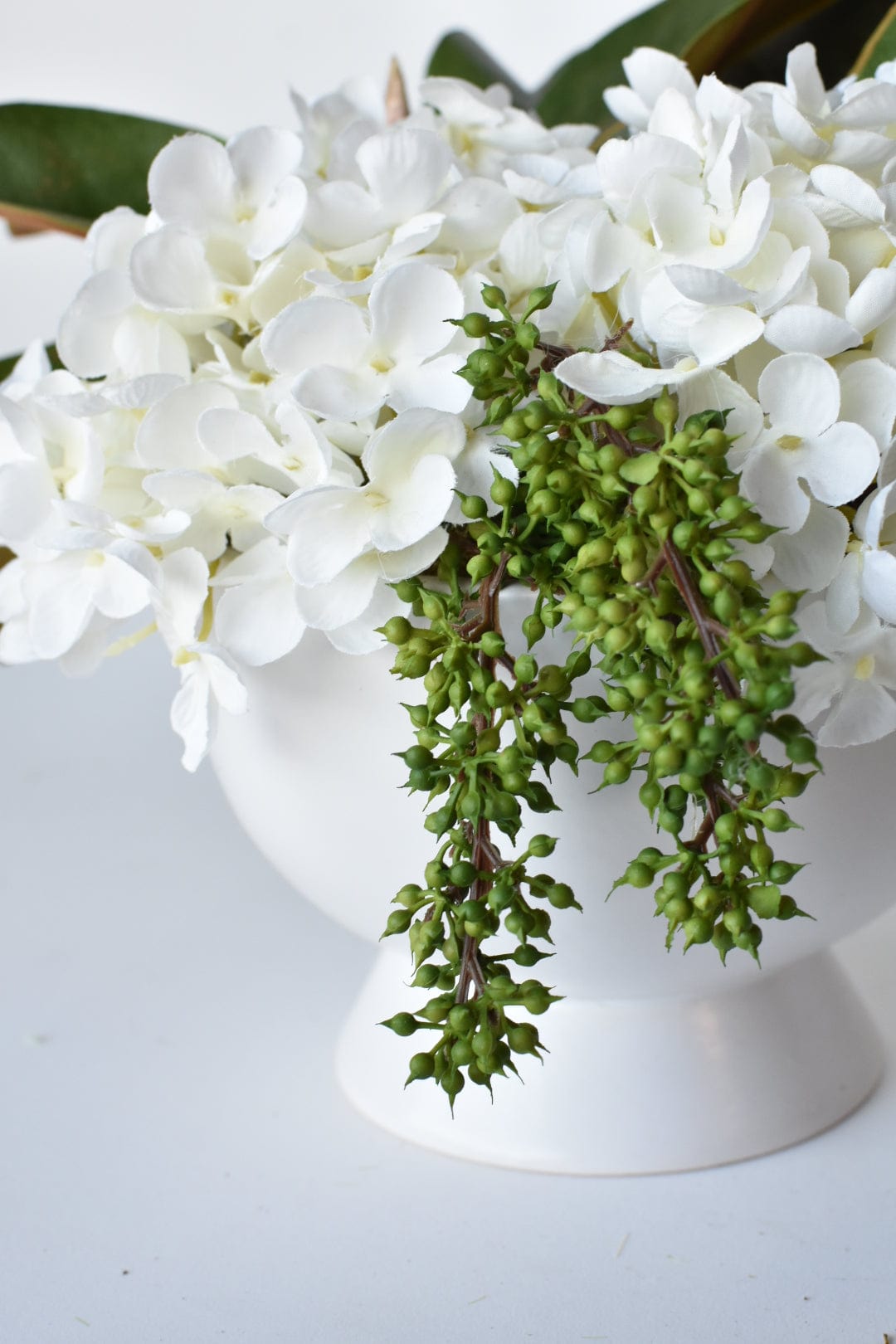 White Hydrangea + Magnolia Leaf Arrangement with Faux Ring Details