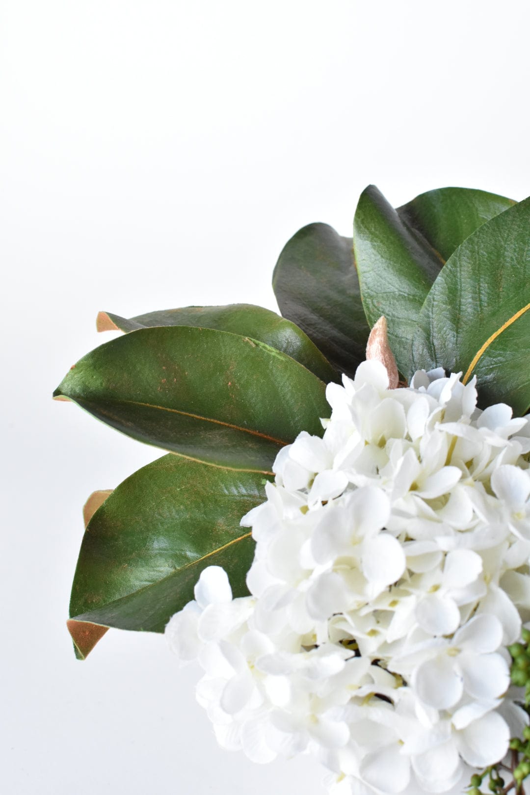White Hydrangea + Magnolia Leaf Arrangement with Faux Ring Details