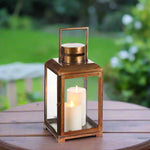 Ashling Lantern Small sitting outside on a tabe at dusk